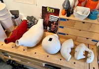 a group of vases on a workbench